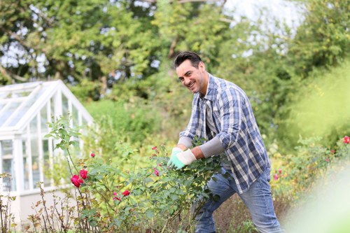 Gardener assessing a lawn with clipboard and safety gear
